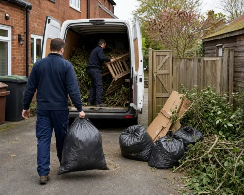 Residential garden waste and bagged rubbish being loaded into a van
